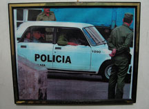A photo of police taking away Espinosa Chepe hangs in his home.