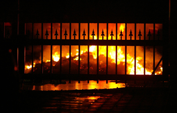 Copies of The Standard burn during a raid in March 2006. Three years later, the government has failed to answer numerous questions about the attack. (AP Photo/Sayyid Azim)