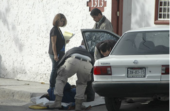 Investigators at the scene of the Rodríguez killing. (AP)