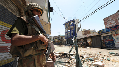A Pakistani soldier amid the rubble of Mingora. (AFP)
