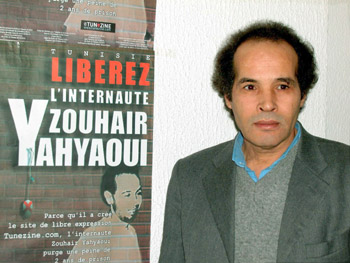 Many Tunisians were outraged by the jailing of blogger Zouhair Yahyaoui. In this 2003 photo, Judge Mokhtar Yahyaoui stands beside a poster of his incarcerated nephew. Zouhair Yahyaoui died shortly after his release from prison. (Mohamed Hammi/Reuters)