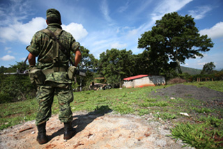A Mexican soldier stands watch over an illegal drug laboratory in Michoacán. (AP)