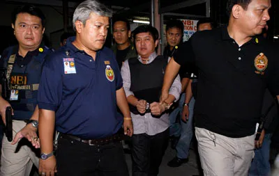 Andal Ampatuan Jr. is escorted to his trial. (Reuters)