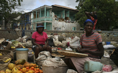 Women sell fruit in Jacmel, where Radio Fondwa was completely destroyed along with much of the city’s downtown. (AP)