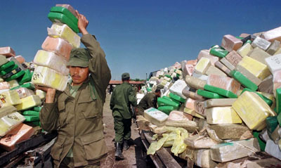 A Mexican soldier carries blocks of cocaine for incineration in Matamoros. (Reuters)