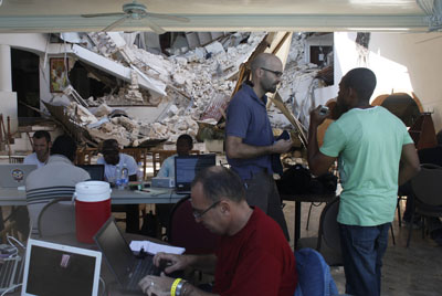 Foreign journalists, seen here working in Port-au-Prince, have flooded into Haiti after the earthquake, but the local media is in tatters. (Reuters/Eliana Aponte)