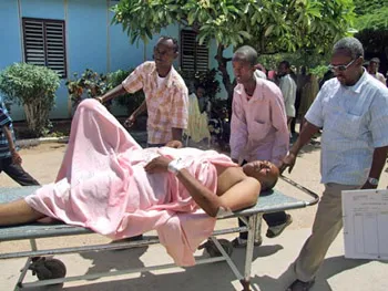 Hashi is taken to a hospital after being shot by Al-Shabaab militants in June 2009. His colleague Mukhtar Mohamed Hirabe was killed in the attack. (AP)