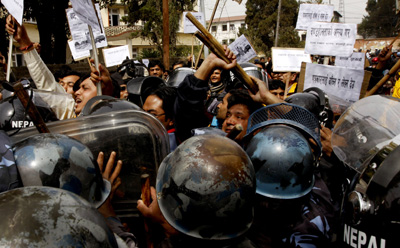 Nepalese riot police block journalists during a protest against the killing Arun Simhaniya. (AP/Binod Joshi)