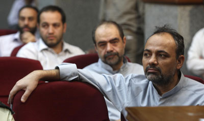 Columnist Ahmad Zaid-Abadi, foreground, at a mass, televised judicial proceeding in 2009. (Reuters)