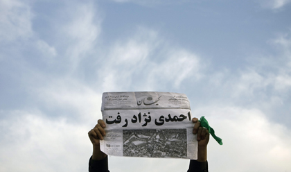 A supporter of former presidential candidate Mir-Hossein Mousavi holds an anti-Ahmadinejad newspaper during a Tehran rally in June 2009. (Morteza Nikoubazl/Reuters)