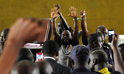 The three defendants handcuffed in court prior to their release. (AFP/Issouf Sanogo)