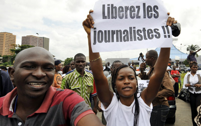 Protesters seek release of three Ivorian editors jailed in a leaked document case. (AFP/Sia Kambou)