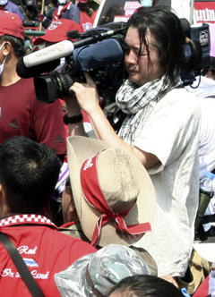 Muramoto is seen here filming clashes between police and protesters shortly before his death. (Reuters)