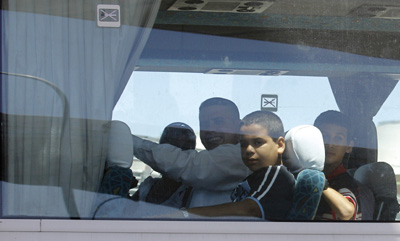 Newly freed Cuban journalists and their families on a bus taking them from Madrid Barajas Airport. (AP/Victor R. Caivano)