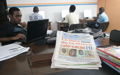 Le Nouveau Courrier’s newsroom with a copy of Tuesday's edition. (Le Nouveau Courrier)