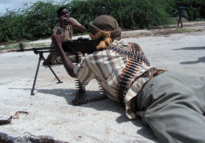 A journalist films an insurgent in Somalia. (Mohammed Ibrahim)