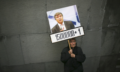 A woman holds a picture of murdered journalist Hrant Dink in 2009. (Reuters)