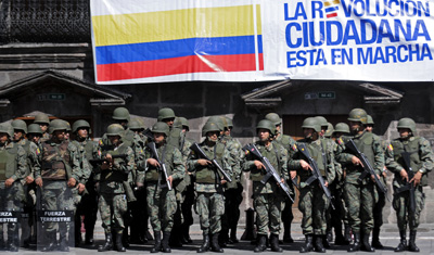 Soldiers guard the government palace in Quito after a police rebellion. (AP/Patricio Realpe)
