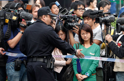 Chinese journalists, seen here at a police roadblock, are contesting harassment more publicly. (AP)