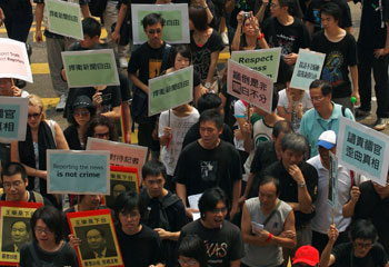 Hong Kong journalists protested the harassment of colleagues covering the Urumqi unrest. But news media were silent when it came to the imprisonment of Uighur editors. (Reuters)