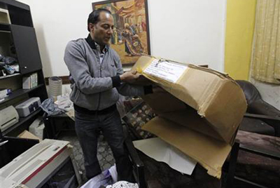 Ziad al-Ajili, head of Baghdad's Journalistic Freedoms Observatory, inspects the aftermath of a raid on his office today. (AP/Hadi Mizban)