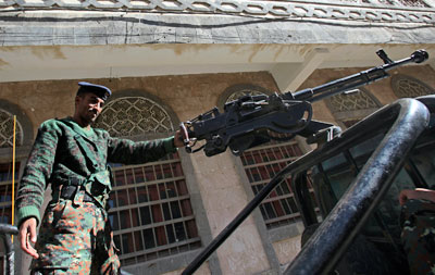 A police trooper stands guard on a police vehicle outside a state security court in Sanaa, Yemen. (Reuters/Khaled Abdullah)