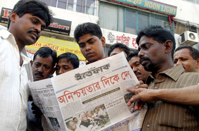 Opposition supporters read a newspaper outside an office of Bangladesh's opposition Awami League party in Dhaka. (Reuters)