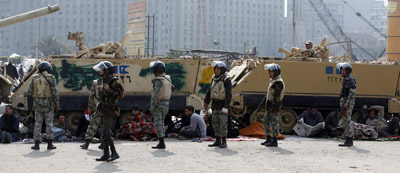 Protesters gather around army vehicles in Cairo's Tahrir Square. (Reuters)