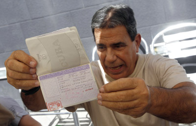 Gálvez Rodríguez shows his passport to the media after his arrival in Spain. (Reuters)