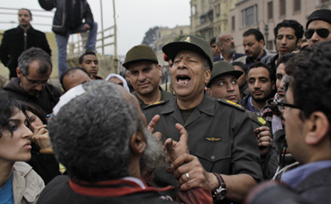 An Egyptian general walks through protests in Tahrir Square. (AP)