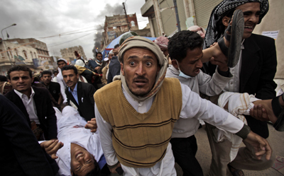 A protester shot by government forces is carried from the scene.(AP/Muhammed Muheisen)
