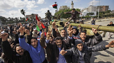 Residents cheer as foreign journalists arrive in Zawiya, 30 miles (50 kilometers) west of Tripoli on Sunday. (AP/Ben Curtis)