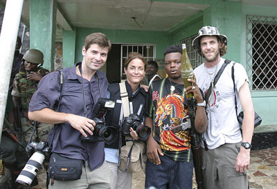 Chris Hondros, Carolyn Cole, a rebel fighter, and the author in Liberia. (Courtesy Nic Bothma)