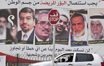 The sign, which depicts some of the men sentenced today, reads at the top: 'Disease must be excised from the body of the nation.' (AP/Hasan Jamali)