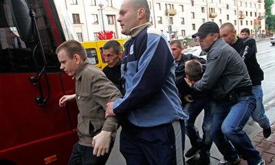 Belarus plainclothes policemen detain protesters during a Minsk protest on Wednesday. (AP)
