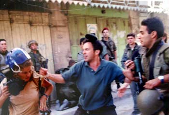 Levine, far left, faces harassment from a Jewish settler in Hebron. (AP)