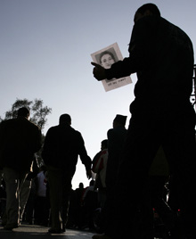 A man holds a photo of Singh. (Reuters)