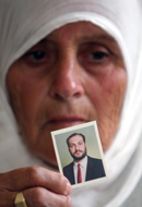 Samer Allawi's mother holds his photo. (AP)