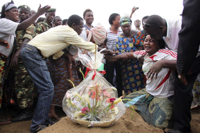 A woman mourns at the burial of a man killed in the Gatumba shooting. (Reuters)