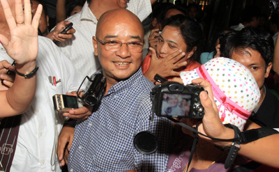 The Burmese comedian and blogger known as Zarganar arrives at the Yangon international airport Wednesday. (AP)
