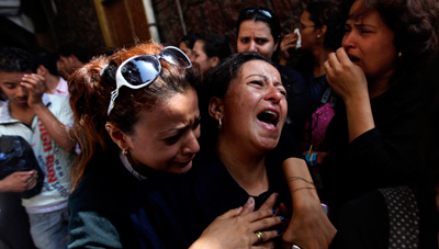 Copts mourn the victims killed during clashes with the Egyptian army. Blogger Alaa Abd el-Fattah was jailed over his coverage.(AP/Khalil Hamra)
