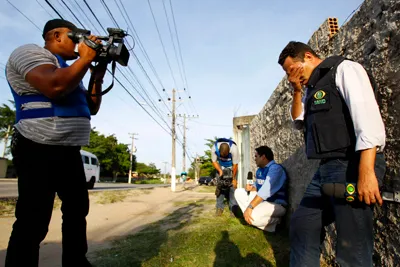 A TV news reporter reacts after journalist Gelson Domingos da Silva is shot and killed. (AP)