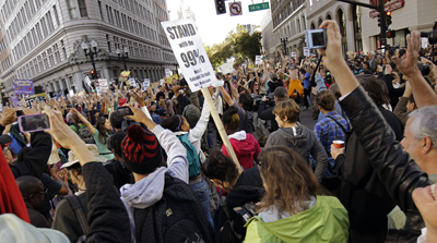 KGO cameraman Randy Davis was assaulted during an Occupy Oakland protest like this one. (AP)