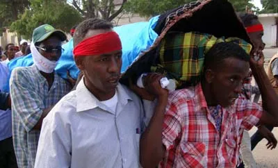 Somali journalists carry the body of Abdisalan Sheikh Hassan of Horn Cable TV who was killed in December 2011. Fear of violence is one of the top reasons why journalists flee into exile. (AFP/Mohamed Abdiwahab)