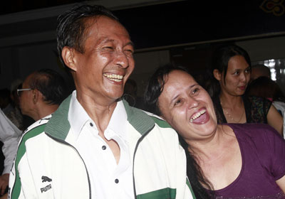 Win Maw, a journalist for Democratic Voice of Burma, is greeted by his wife as he arrives at Yangon airport after being released from prison Friday, Jan. 13. (AP/Khin Maung Win)