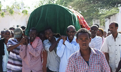 Somali people carry the coffin of journalist Hassan Osman Abdi, who was killed on Saturday evening. (AFP/Mohamed Abdiwahab)