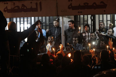 Syrians hold a candlelight vigil as the body of French tv reporter Gilles Jacquier is taken out of a hospital in Homs to be transported to Damascus early on Thursday. (AFP/Joseph Eid)