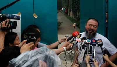 Ai Weiwei speaks to journalists at his home in Beijing after the government held him incommunicado for nearly three months. (AP/Ng Han Guan)