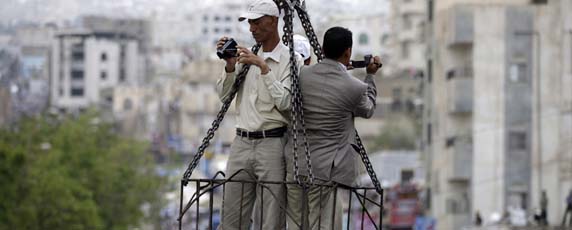 From a crane high above a protest, journalists film crowds in the Yemeni city of Taiz. (Reuters/Khaled Abdullah)