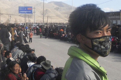 Tibetans gather on the side of a street in Nangqian county, China's Qinghai province, to protest Chinese rule. (AP)